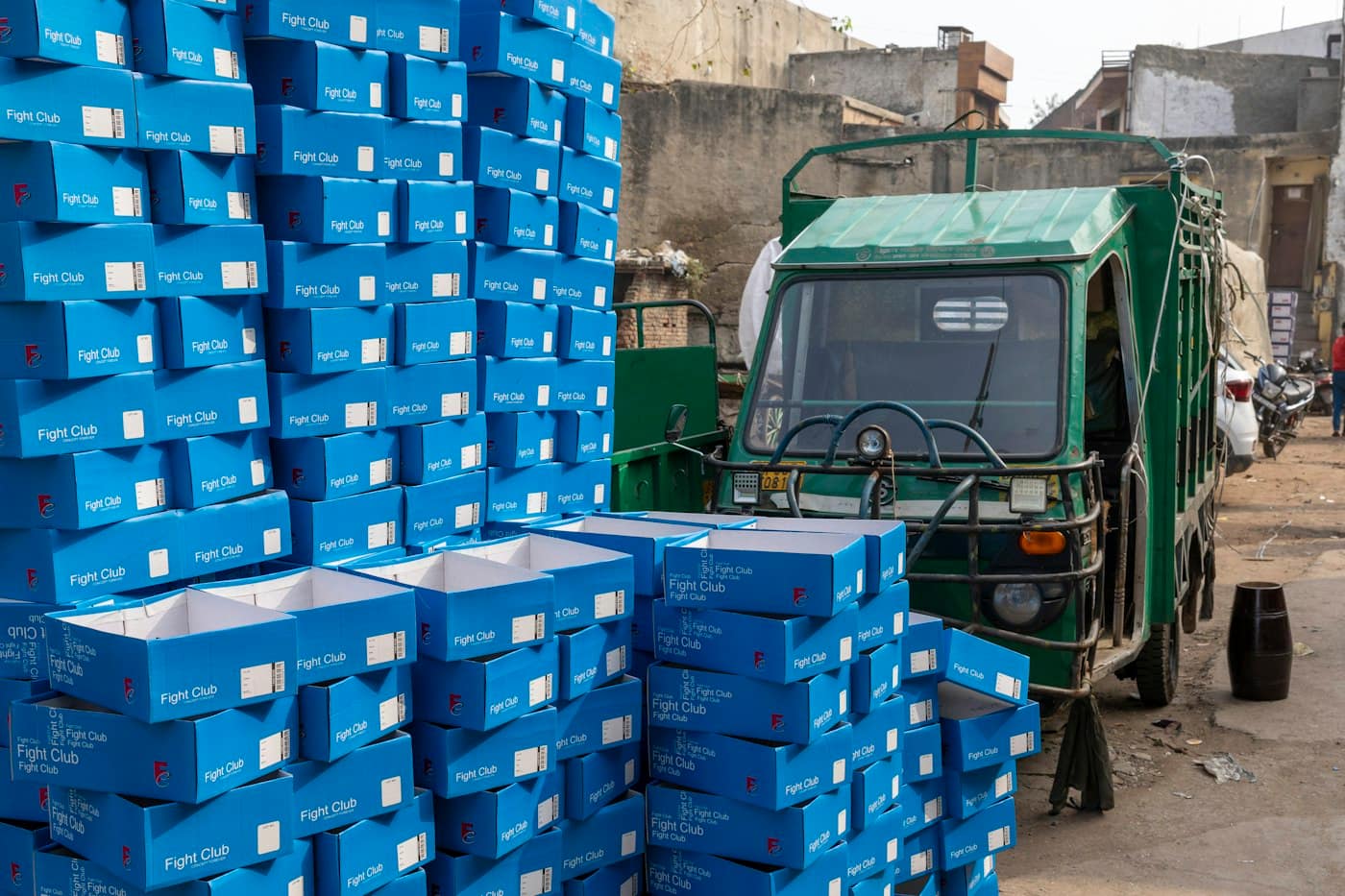 A goods truck beside stacked boxes